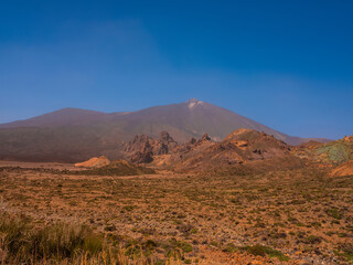 spot in Tenerife with many red rocks and beautiful mountain landscape background