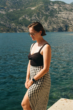 A lady standing in front of the Kotor's bay