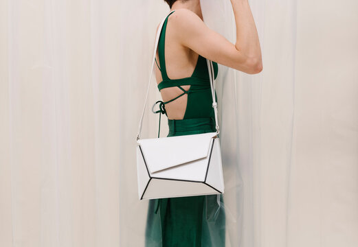 Stylish Woman Wearing Elegant Green Dress And White Handbag