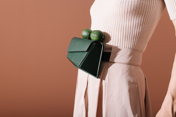 Stylish Woman Wearing Green Handbag With Limes On Belt