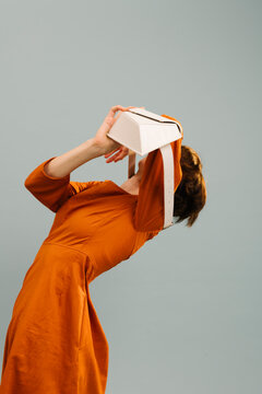 Woman In Orange Dress Experiencing Virtual Reality Technology