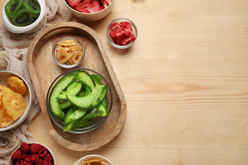 Bowls of different dehydrated fruits and berries on wooden background