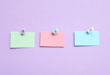 Paper notes pinned on lilac background