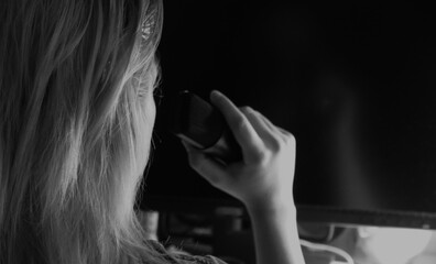 Fototapeta premium Woman speak in the microphone in studio black and white