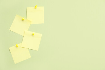 Yellow paper notes pinned on green background