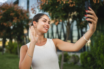Young woman stand in front company have video call on mobile phone