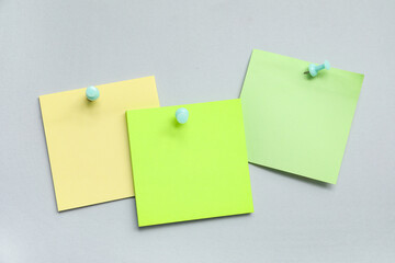 Paper notes pinned on grey background