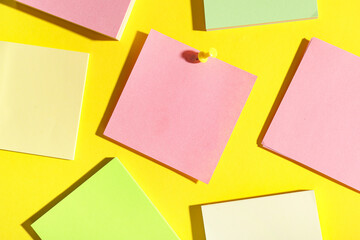 Pink paper note pinned on yellow background