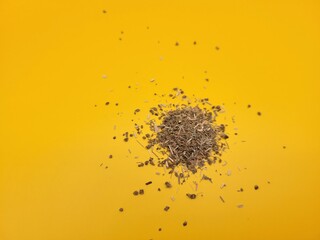 Dried lemongrass on a yellow background.