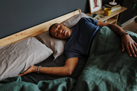 Man sleeping peacefully in bed at home