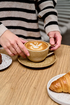 Woman holding Warm cup of latte