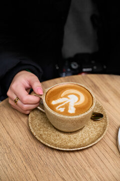 Woman holding Warm cup of latte