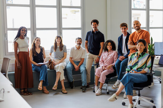 Professionals posing together in modern office