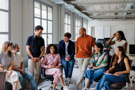 Diverse team of professionals sharing a laugh together in the office