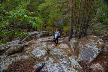 Young woman taking selfie n the woods. Nature concept. High quality photo