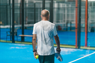 Male Padel Player Holding Ball
