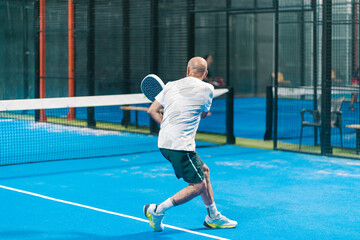 Male Padel Player Returning Ball
