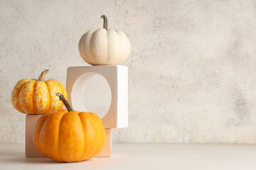Decorative podiums with fresh pumpkins on white background
