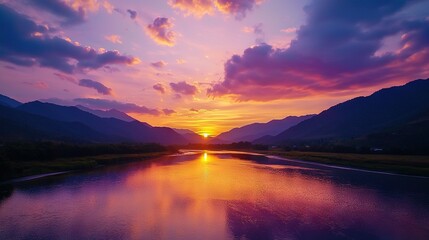 Fototapeta premium A serene lake bathed in sunset hues with majestic mountains reflected in its depths and fluffy clouds overhead