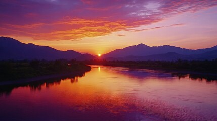 Naklejka premium A stunning sunset over a serene body of water, set against a backdrop of majestic mountains, with a boat anchored peacefully in the center of it all