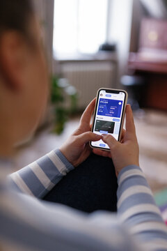 Woman using banking application to track her incomes and expenses