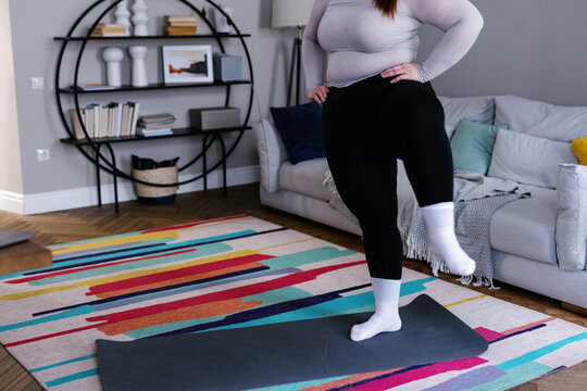 Cropped photo of plus size woman doing leg exercise at home workout - Powered by Adobe