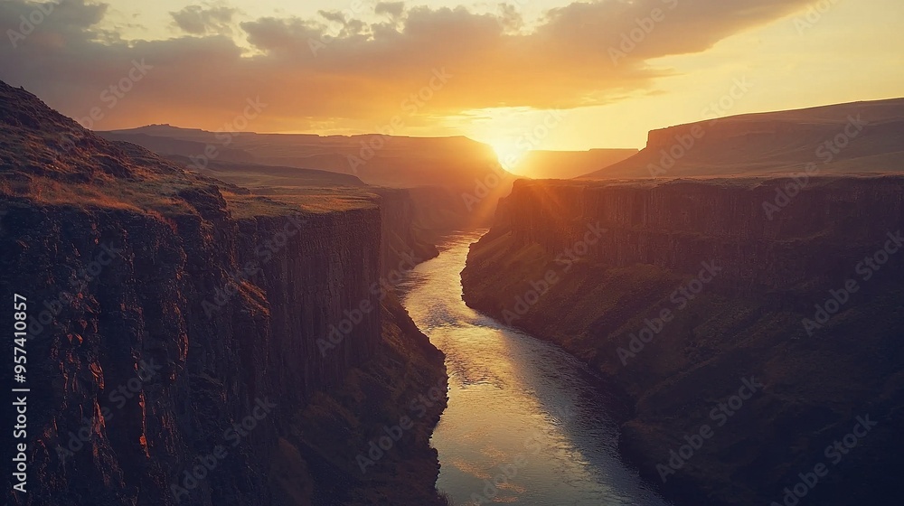 Poster the sun is setting over a canyon with a river in the foreground and a cliff in the distance