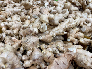 Close up of a pile of fresh ginger root for sale