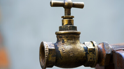 old brass water tap, Vintage. tap valve. old copper retro faucet on a rusty pipe. plumbing, repair, dismantling. close-up. isolated, space for text. water problems