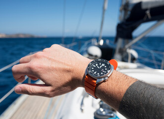 Man's Hand with Watch on Sailboat