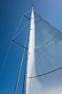 Sailboat Mast and Sail Against Blue Sky