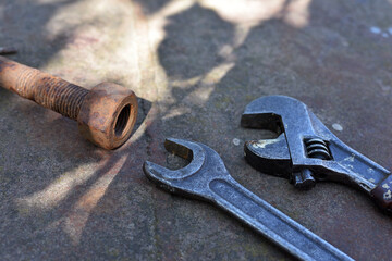 rusty nut. bolt and nut. adjustable wrench, spanner, tools. Rusted mechanical components. dismantling, difficult to unscrew, non-removable. corrosion, oxidation. industry. selective focus.