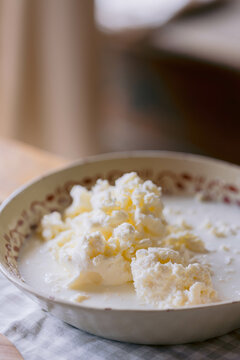 Close-up of fresh homemade butter in a patterned bowl.
