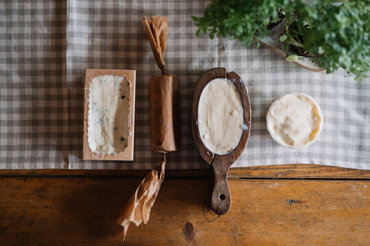 Assorted homemade butter shapes on wooden table with cloth