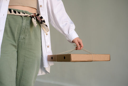 Woman Holding Pizza Box Tied With String 