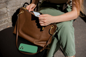 Woman Getting Out Credit Card From Brown Leather Handbag