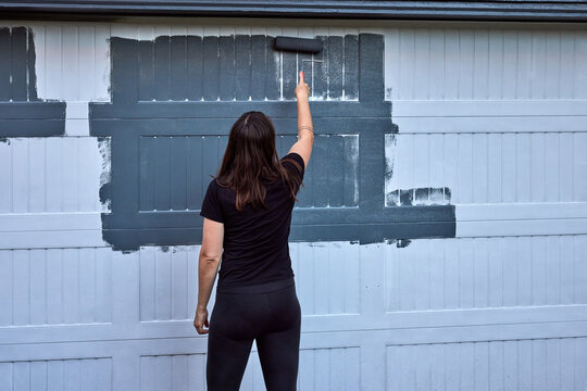 Woman painting the garage
