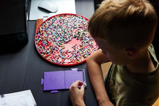 Little boy doing perler beads