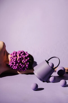 Surreal Art Concept with Purple Pom Poms and Bucket