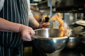 Chips Fries Being Tossed with Seasoning with motion blur