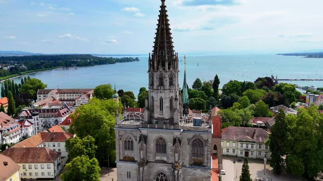 Revealing a Church Surrounded by Trees and Houses with Bodensee in the Background