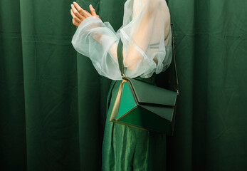Elegant Woman Wearing Green Dress with Fashionable Handbag