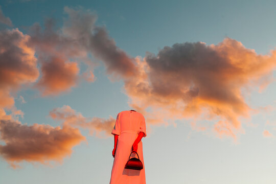 Surreal Image of Headless Woman against Sunset Sky