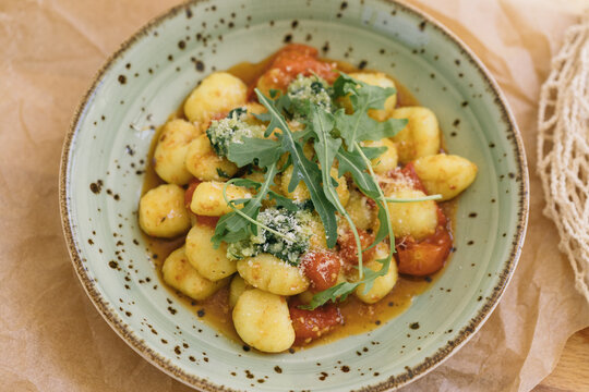 Homemade gnocchi with tomatoes and basil
