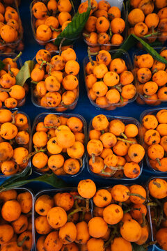 Fresh Loquats in Market Containers