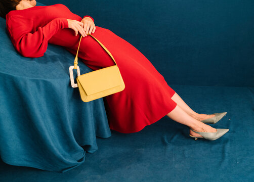 Fashionable Woman in Red Dress with Yellow Handbag
