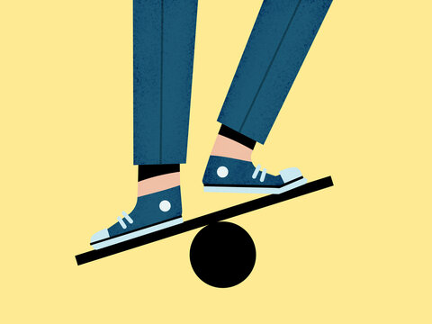 Unrecognizable man balancing on ball