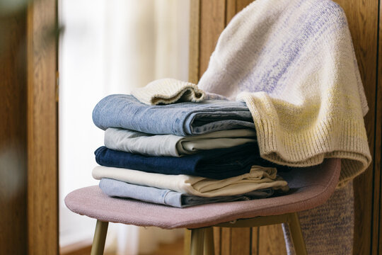 A pile of clothes on a chair