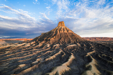 Factory Butte, massive ancient sandstone natural structure surrounding by incredible landscape .