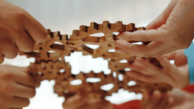 Panorama video of employee together connect wooden cogwheel gear symbol harmonious function productive system in business company and synergy teamwork with effective and efficiency working. Synergic